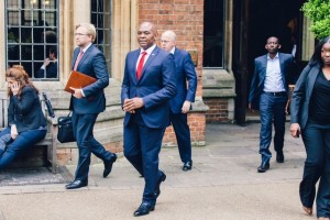 Tony Elumelu departs the Oxford Union with his team after his speech